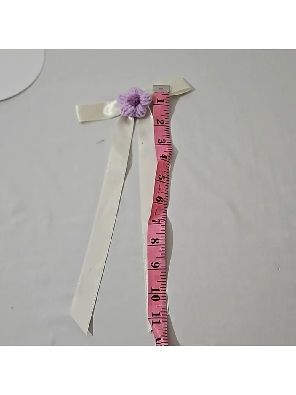 Hand Crafted Ivory Bow with Purple Crochet Flower